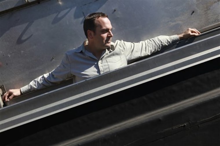 In this photo taken Wednesday, May 5, 2010, Erik Proulx, a former advertising copywriter, is seen on the roof of an office building where he maintains an office in Boston. Proulx says he no longer wants to rejoin an industry he thinks will continue to struggle.